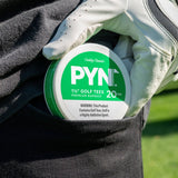 Container of golf tees held by a gloved hand with a grassy background