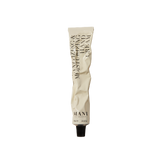 White hand cream tube with black text on a white background