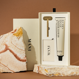 Skincare product set with a marble-textured base on a brown background