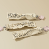 Three tubes of 'Hand Cream' on a beige background