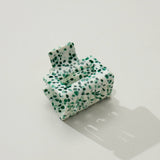 Green and white patterned inflatable chair on a light gray surface