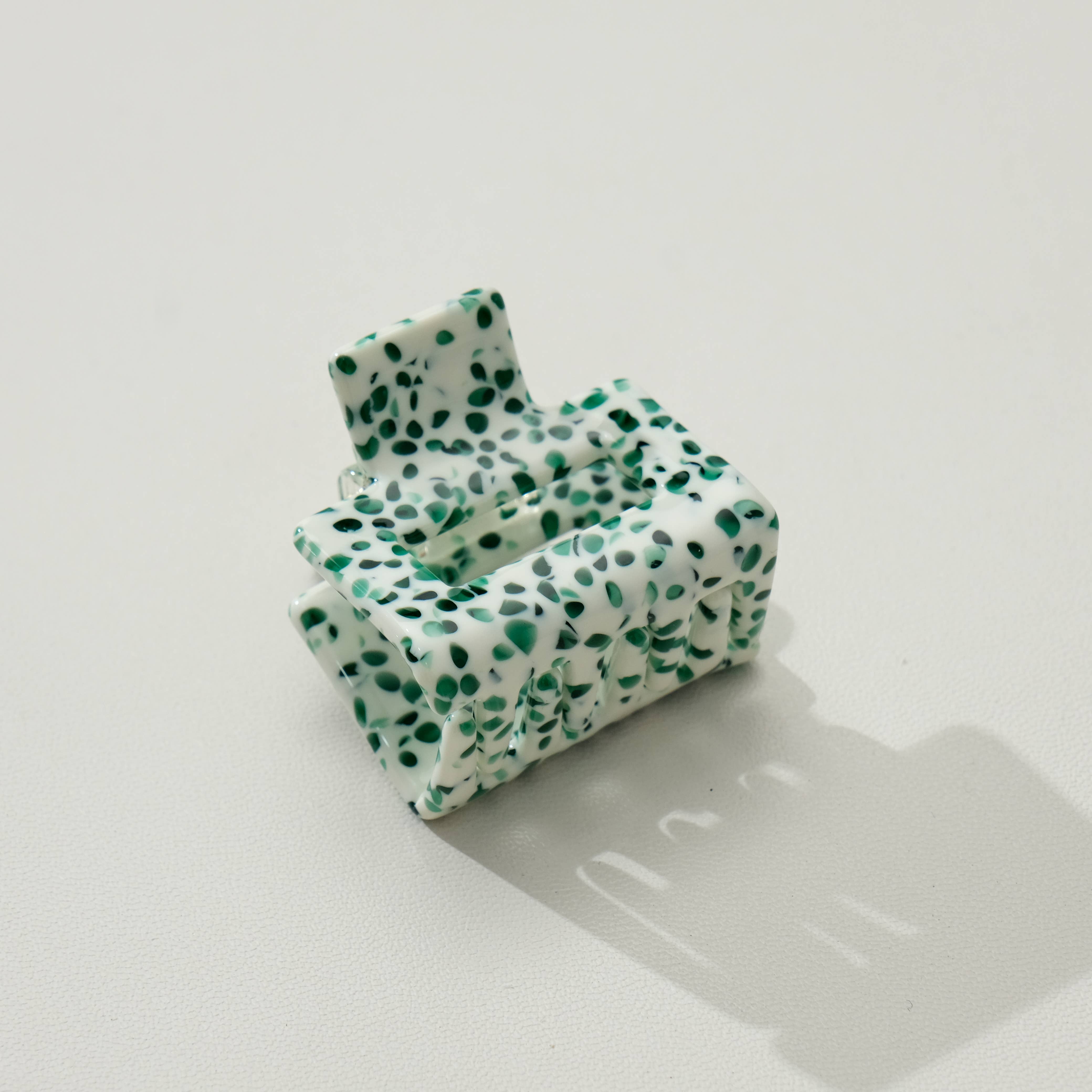 Green and white patterned inflatable chair on a light gray surface
