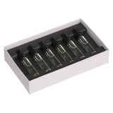 Set of clear glass vials in a white box with black interior