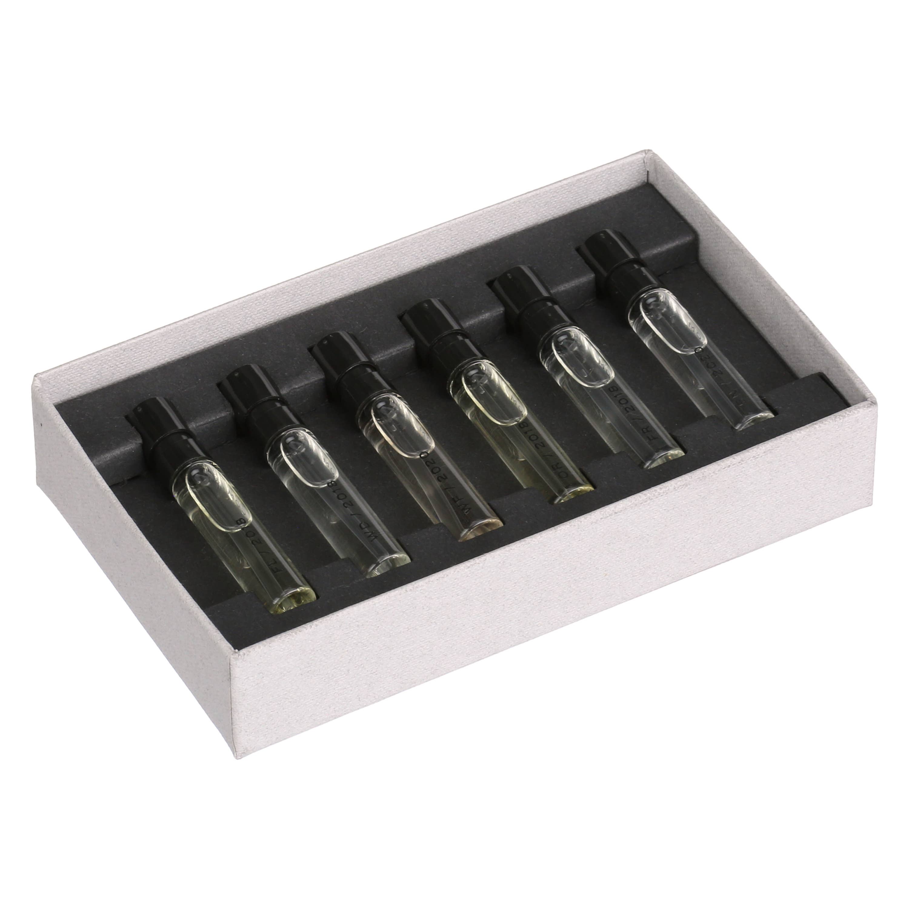 Set of clear glass vials in a white box with black interior